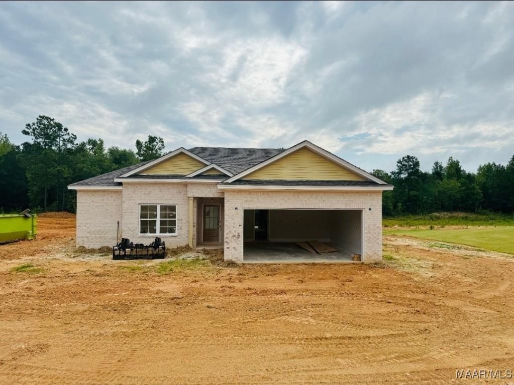 134 Madix Dr, Eclectic, AL 36024 - view of front facade featuring an attached garage, brick siding, driveway, and a shingled roof