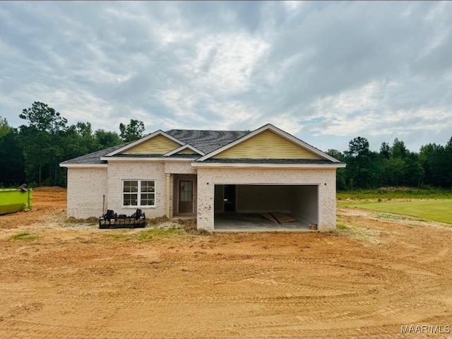 134 Madix Dr, Eclectic, AL 36024 - view of front facade featuring an attached garage, brick siding, driveway, and a shingled roof