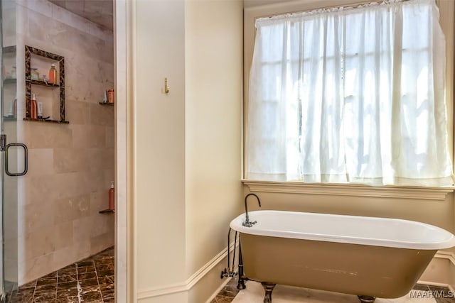 8573 W Hampton Ct, Montgomery, AL 36117 - bathroom featuring a stall shower, a soaking tub, and baseboards