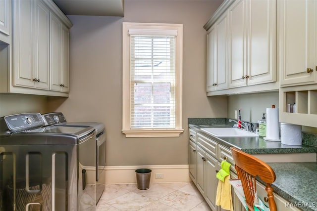 8573 W Hampton Ct, Montgomery, AL 36117 - clothes washing area with a sink, baseboards, cabinet space, and washing machine and dryer