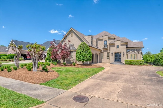8573 W Hampton Ct, Montgomery, AL 36117 - view of front of house with a front yard, driveway, french doors, and stucco siding