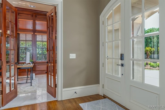 8573 W Hampton Ct, Montgomery, AL 36117 - foyer entrance with french doors, wood finished floors, baseboards, and visible vents