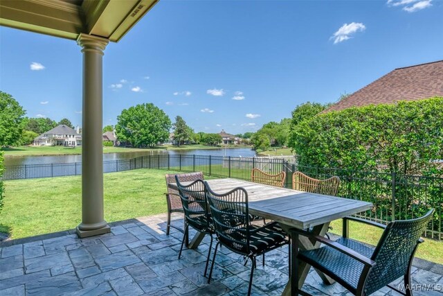 8573 W Hampton Ct, Montgomery, AL 36117 - view of patio featuring a water view, a fenced backyard, and outdoor dining space