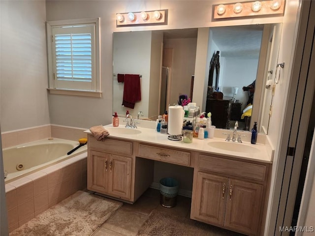 bathroom with ensuite bath, a tub with jets, tile patterned flooring, a sink, and double vanity