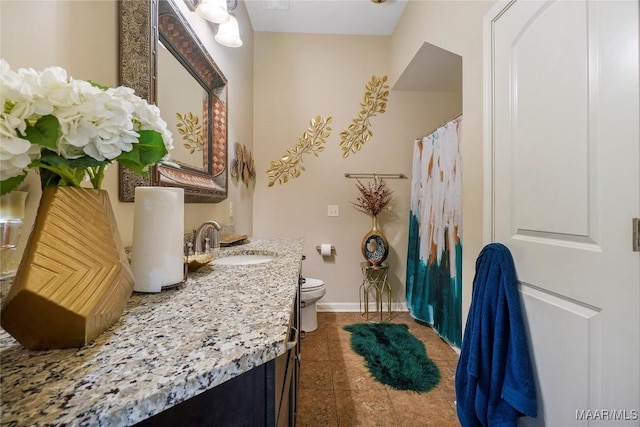 bathroom with vanity, baseboards, curtained shower, tile patterned flooring, and toilet