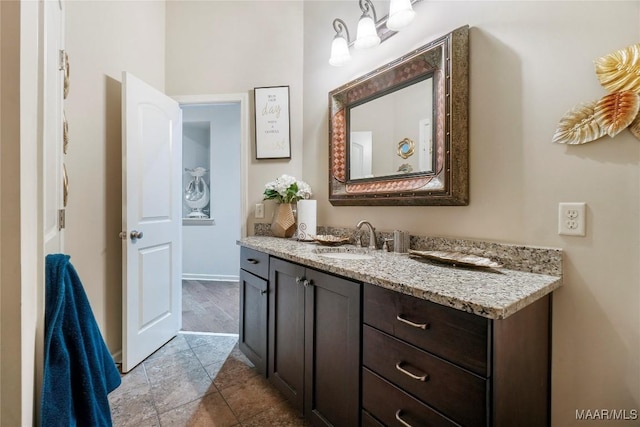 bathroom with baseboards and vanity