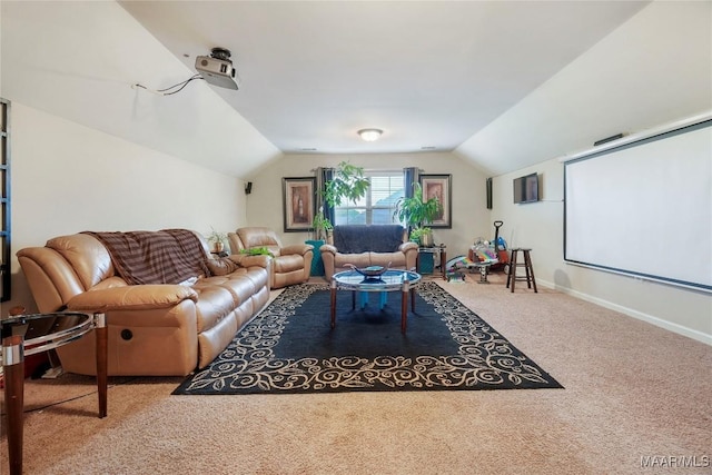 carpeted cinema room featuring baseboards and vaulted ceiling