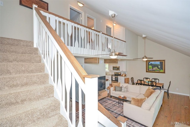 315 Lake Point Dr, Jacksons Gap, AL 36861 - living area with baseboards, a ceiling fan, stairway, wood finished floors, and high vaulted ceiling