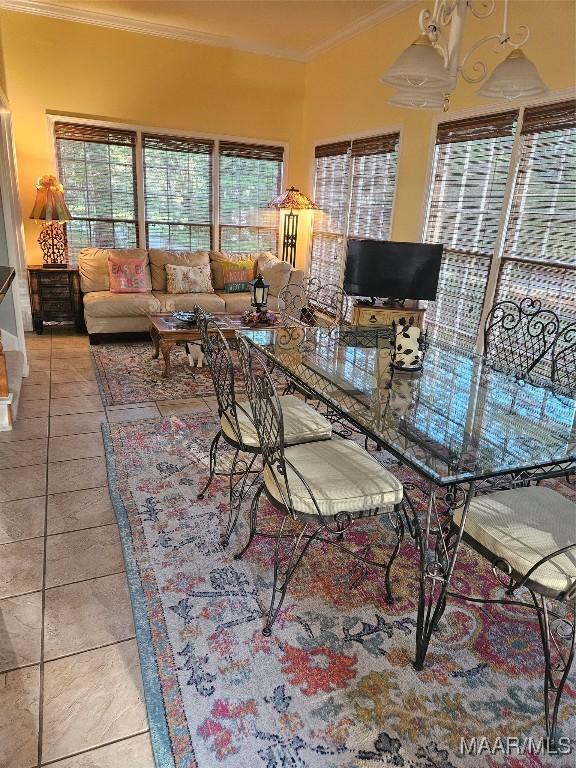 dining space featuring light tile patterned floors and crown molding
