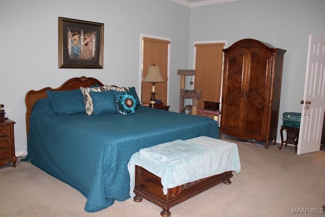 carpeted bedroom featuring crown molding