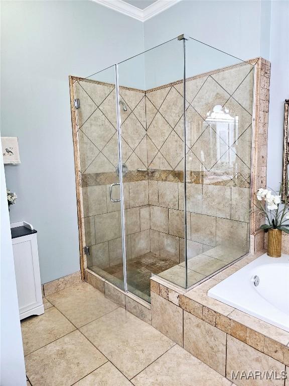 bathroom with tile patterned floors, a garden tub, ornamental molding, and a stall shower