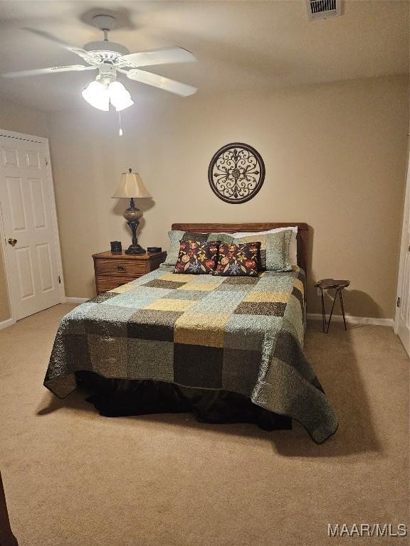 bedroom featuring baseboards, a ceiling fan, and carpet