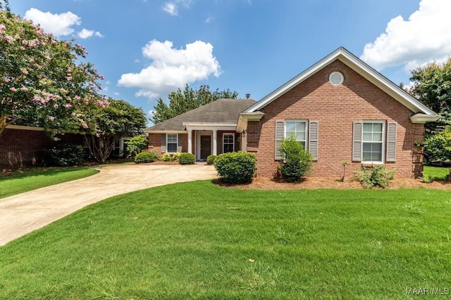 ranch-style home with brick siding and a front lawn
