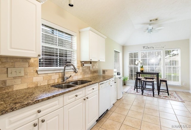 kitchen featuring tasteful backsplash, a ceiling fan, visible vents, dishwasher, and a sink