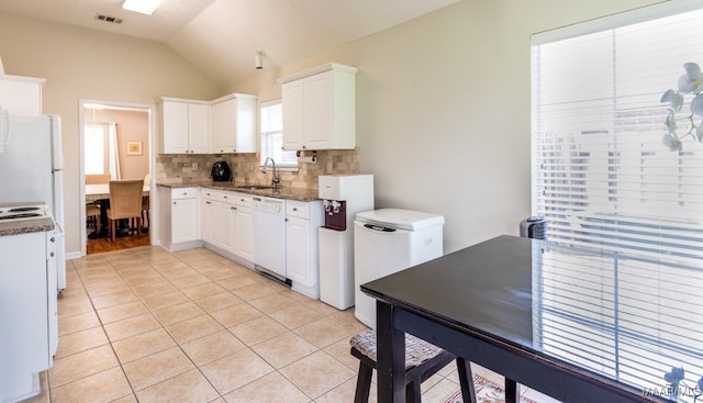 kitchen featuring white appliances, tasteful backsplash, white cabinetry, visible vents, and light tile patterned flooring