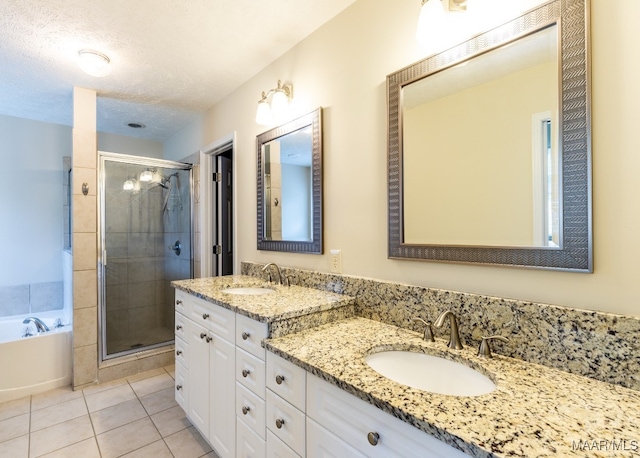 bathroom featuring a shower stall, a bath, and a sink