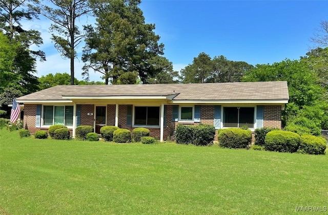 single story home with brick siding and a front lawn