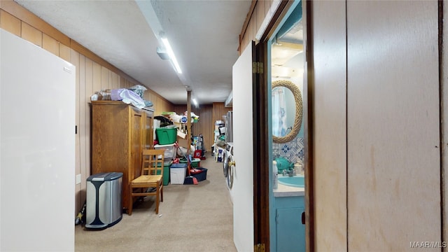 hallway with light carpet and wooden walls
