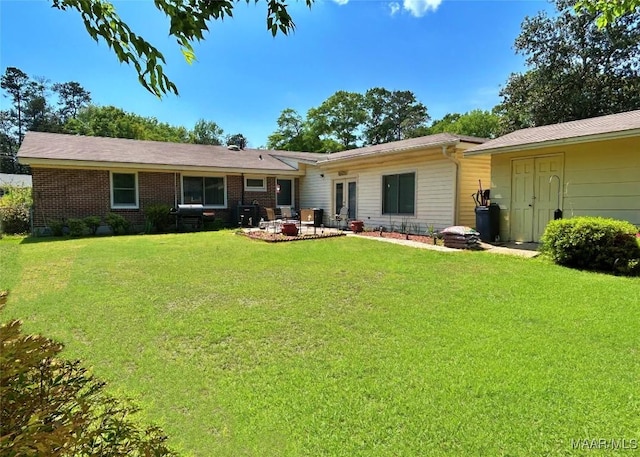 back of house featuring a yard and french doors
