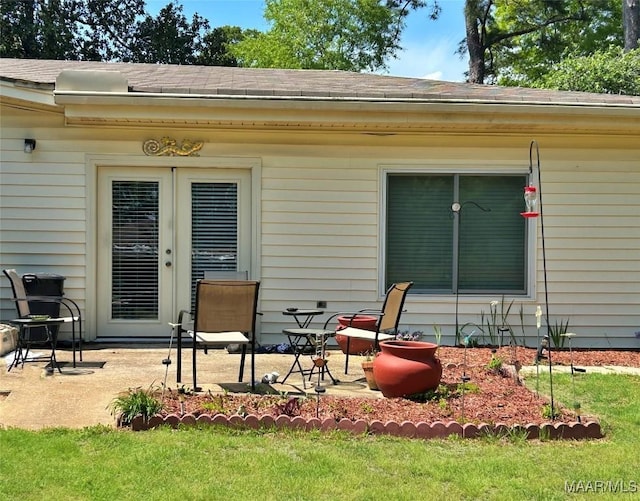 exterior space with a patio and roof with shingles
