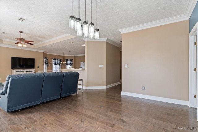 living area featuring visible vents, ceiling fan with notable chandelier, wood finished floors, and a textured ceiling