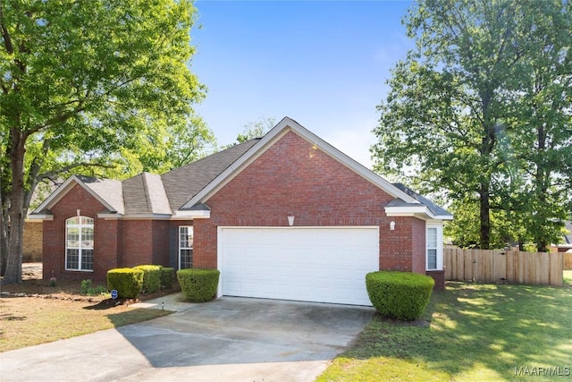view of front facade featuring concrete driveway, an attached garage, a front yard, brick siding, and fence