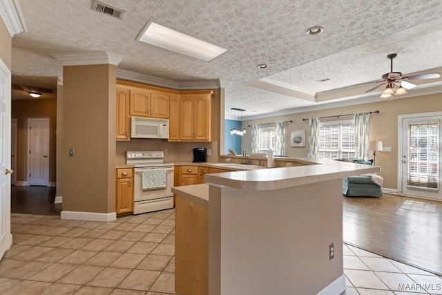 kitchen with crown molding, light tile patterned floors, white appliances, a peninsula, and visible vents