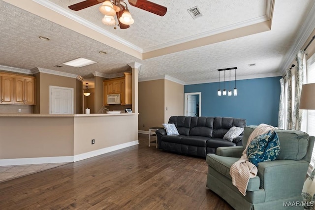 living area featuring ceiling fan, a textured ceiling, visible vents, baseboards, and dark wood-style floors