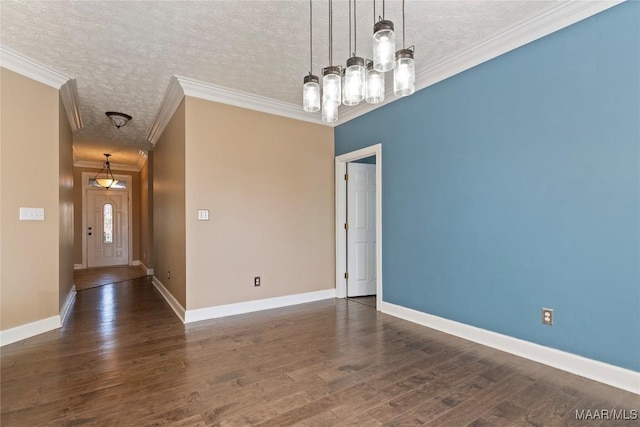 unfurnished dining area featuring crown molding, baseboards, wood finished floors, and a textured ceiling
