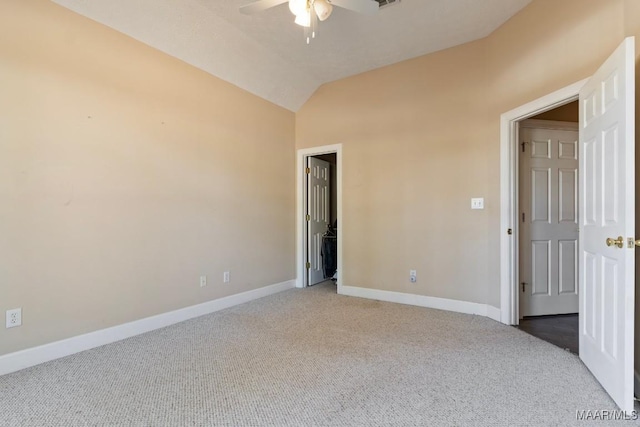 unfurnished bedroom featuring carpet floors, baseboards, and vaulted ceiling