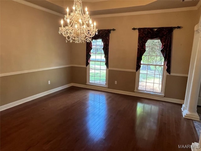 empty room with decorative columns, baseboards, ornamental molding, and dark wood-style flooring