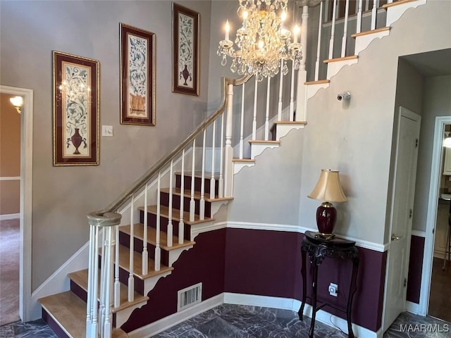 stairway featuring visible vents, baseboards, marble finish floor, and a chandelier
