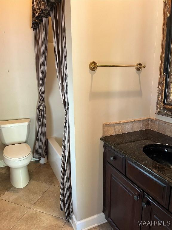 full bath featuring vanity, tile patterned flooring, and toilet