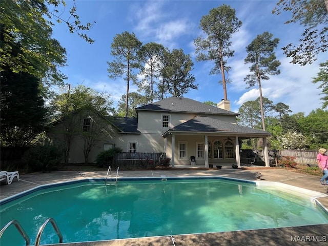 view of swimming pool featuring fence, a patio, and a fenced in pool