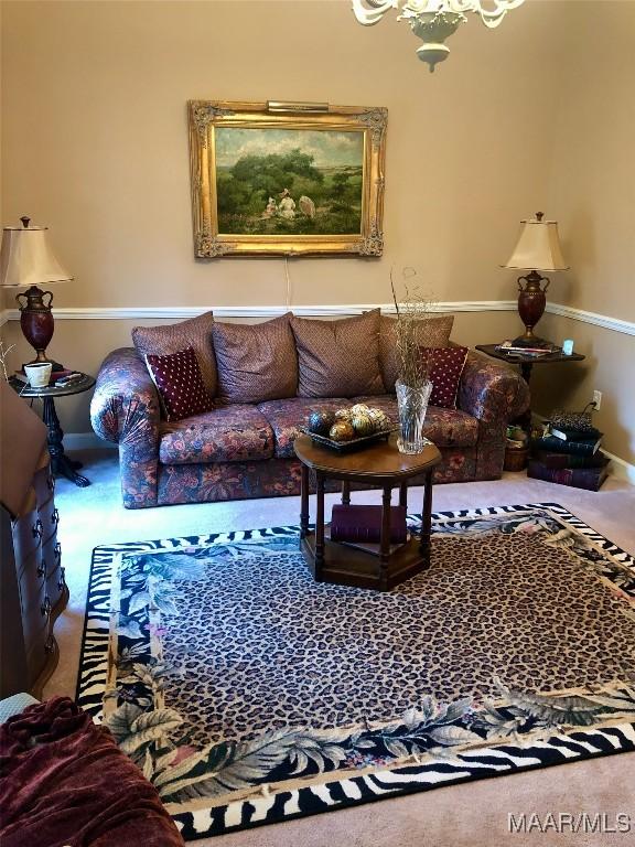 carpeted living area featuring baseboards