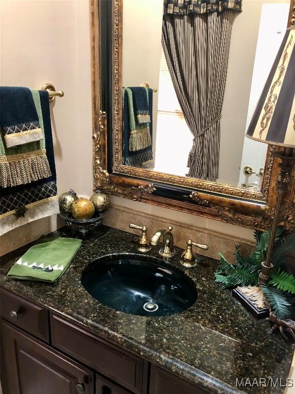 bathroom with vanity and backsplash