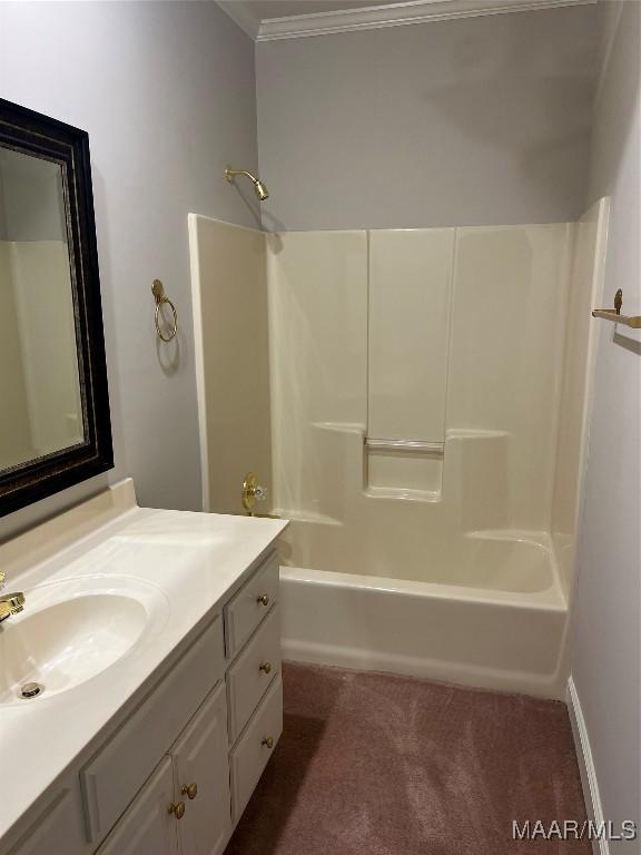 bathroom with ornamental molding, vanity, and shower / bathing tub combination