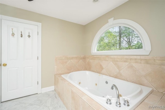 bathroom featuring a tub with jets