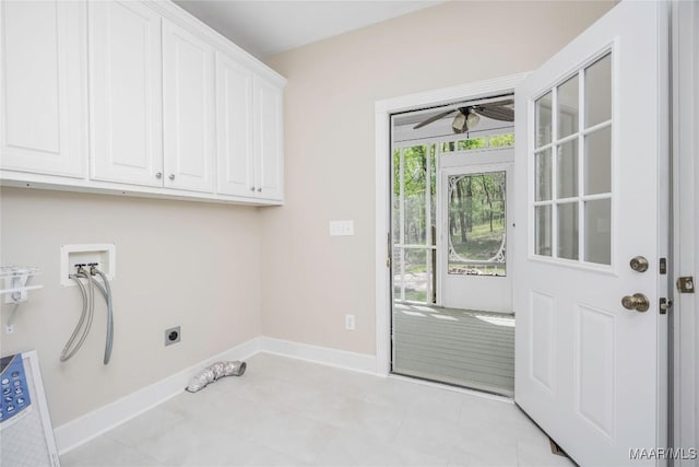 washroom with hookup for an electric dryer, baseboards, a ceiling fan, hookup for a washing machine, and cabinet space