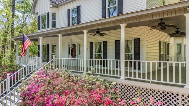 doorway to property featuring covered porch and a ceiling fan