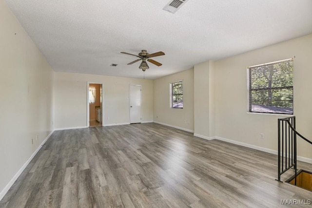 210 Weluvit Ln, Titus, AL 36080 - spare room with wood finished floors, ceiling fan, a textured ceiling, and baseboards