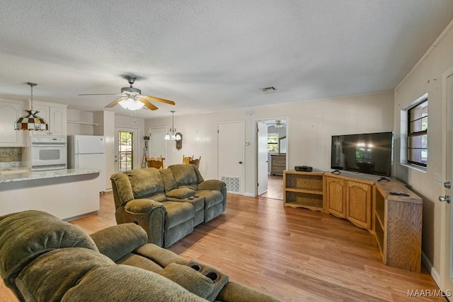 210 Weluvit Ln, Titus, AL 36080 - living room featuring a ceiling fan, light wood-type flooring, and a textured ceiling