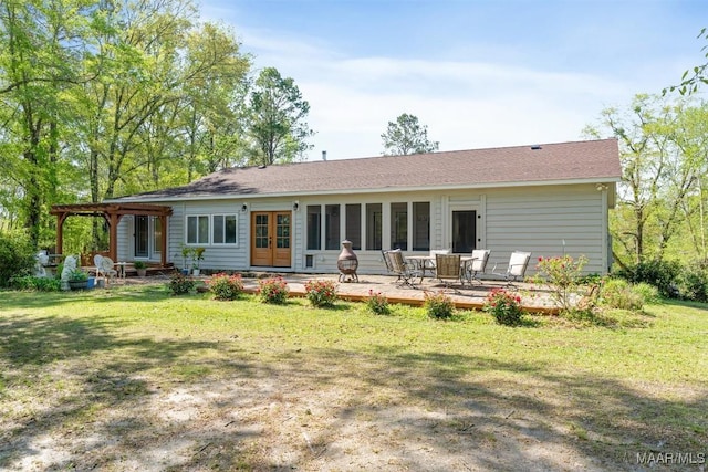 back of house with a pergola, a deck, and a lawn