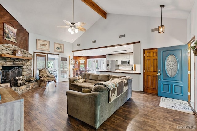 living area featuring dark wood-type flooring, visible vents, high vaulted ceiling, and a ceiling fan