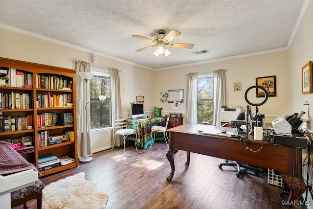 office space featuring visible vents, a wealth of natural light, a ceiling fan, and a textured ceiling