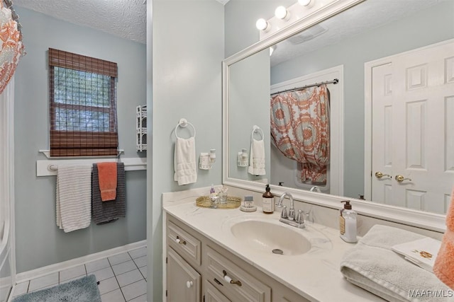 bathroom featuring vanity, baseboards, curtained shower, tile patterned floors, and a textured ceiling