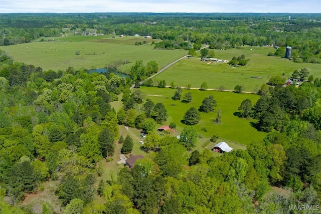 drone / aerial view with a view of trees and a rural view