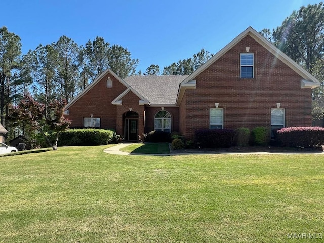 traditional-style house with a front yard and brick siding