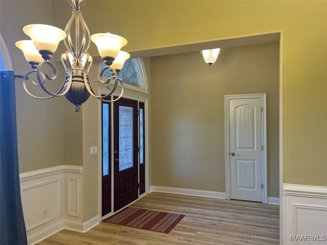 foyer entrance featuring a chandelier and wood finished floors