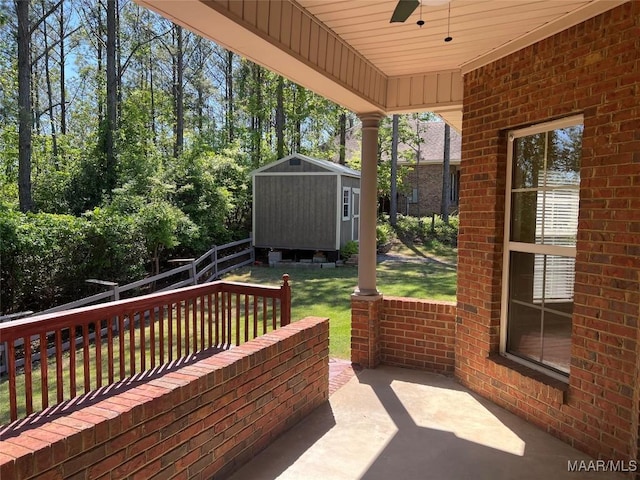 exterior space with a storage shed, an outdoor structure, and ceiling fan